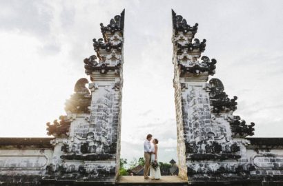 Wedding couple in Pura Lempuyang temple in Bali. Famous indonesian landmark, traditional balinese gate.